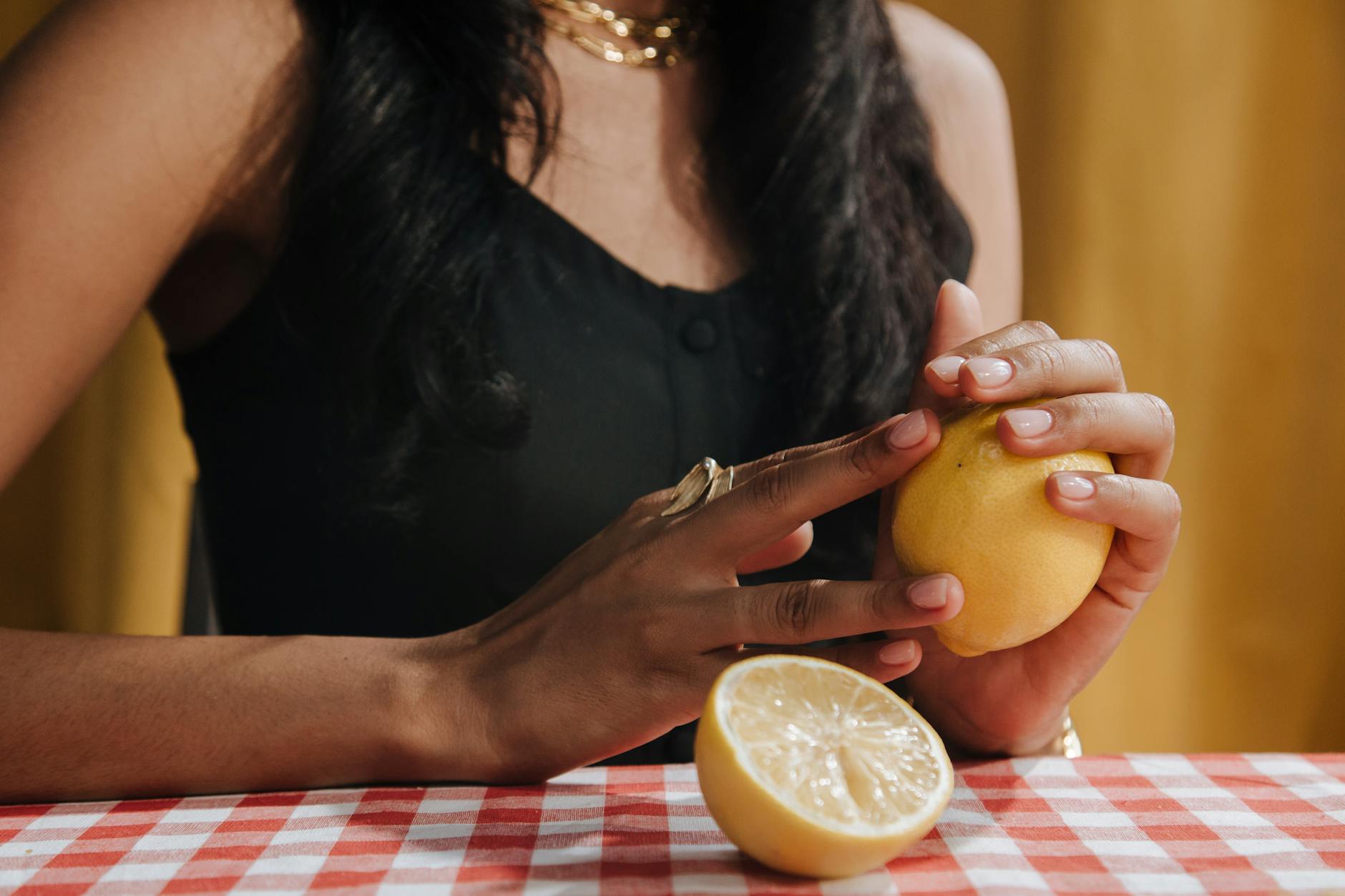 Yellow silicone vibrator surrounded by peeled bananas on yellow background
