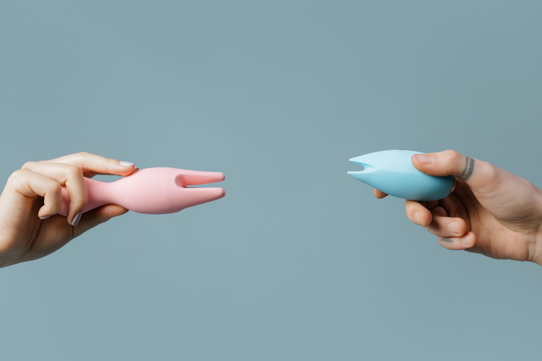 A hand holding an orange vibrator against a purple backdrop, symbolizing sensual awakening and rediscovery.