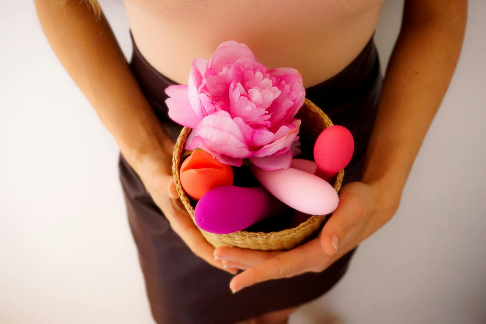 A basket of colorful vibrators and flowers, symbolizing pleasure reclaimed amid life's chaos
